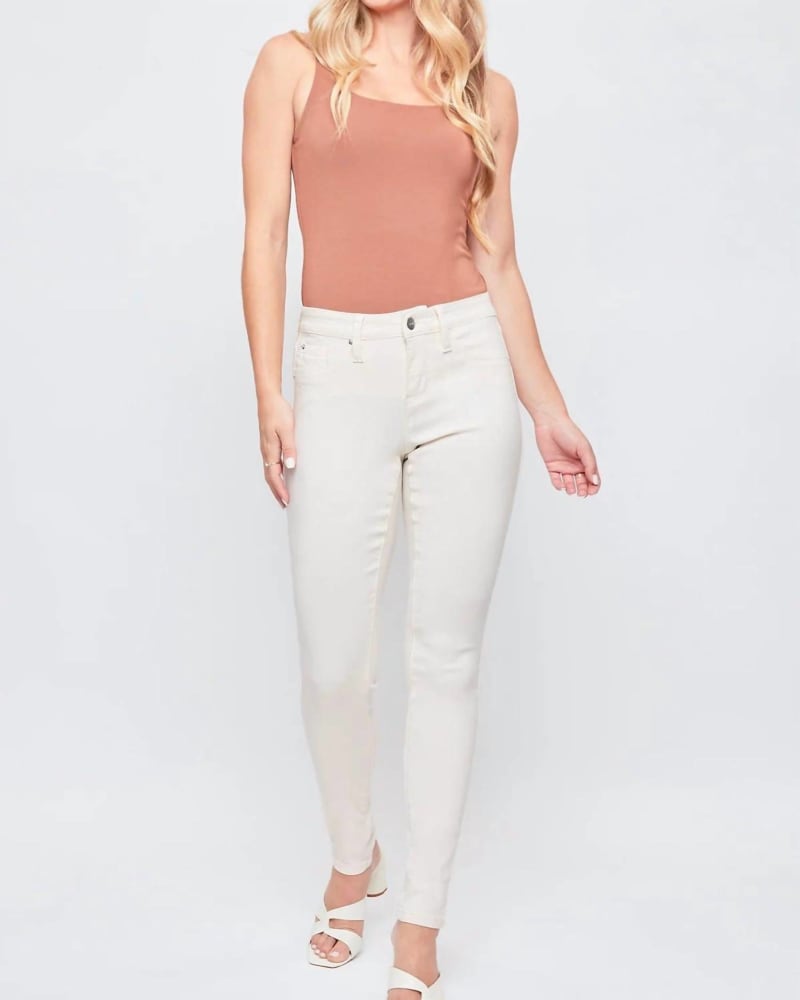 Front of a model wearing a size 3X Hyperstretch Skinny Jean in Gardenia in Gardenia by YMI. | dia_product_style_image_id:338261